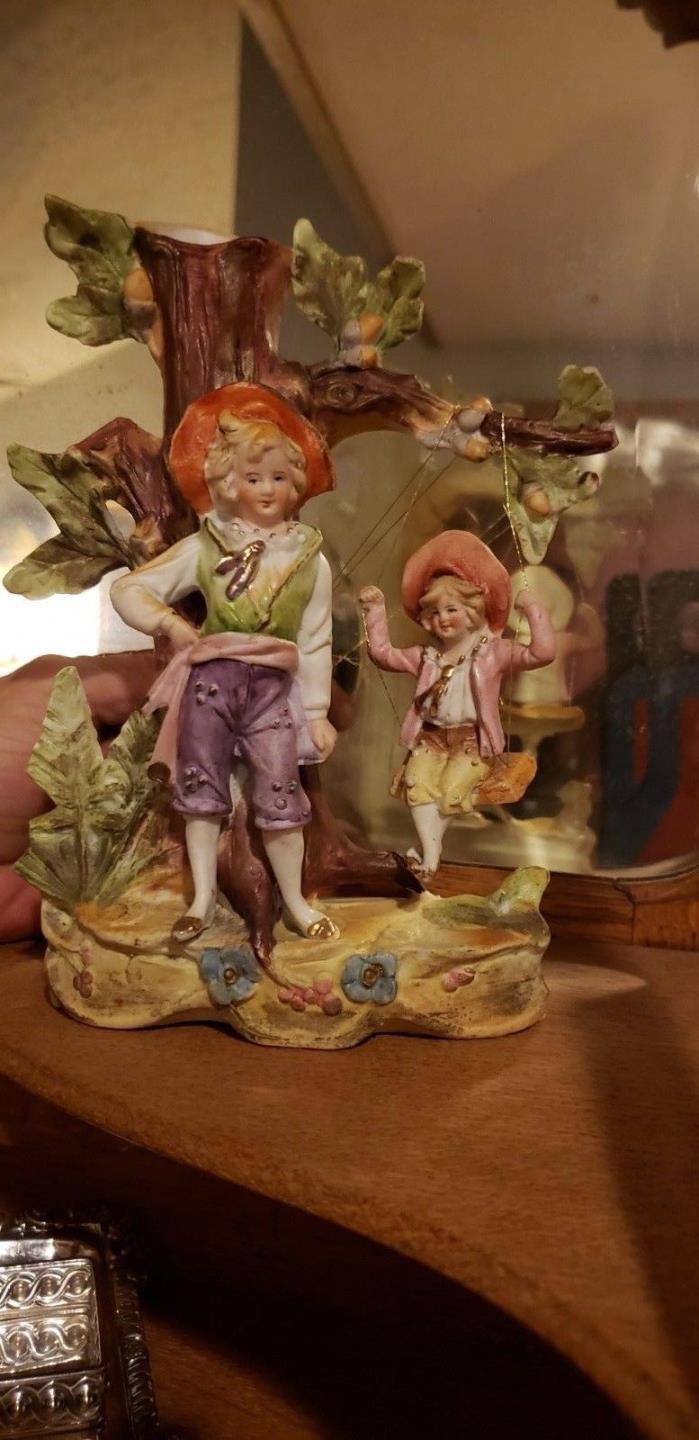 man with boy on swing antique bisque Spill Vase tree foliage flowers Excellent