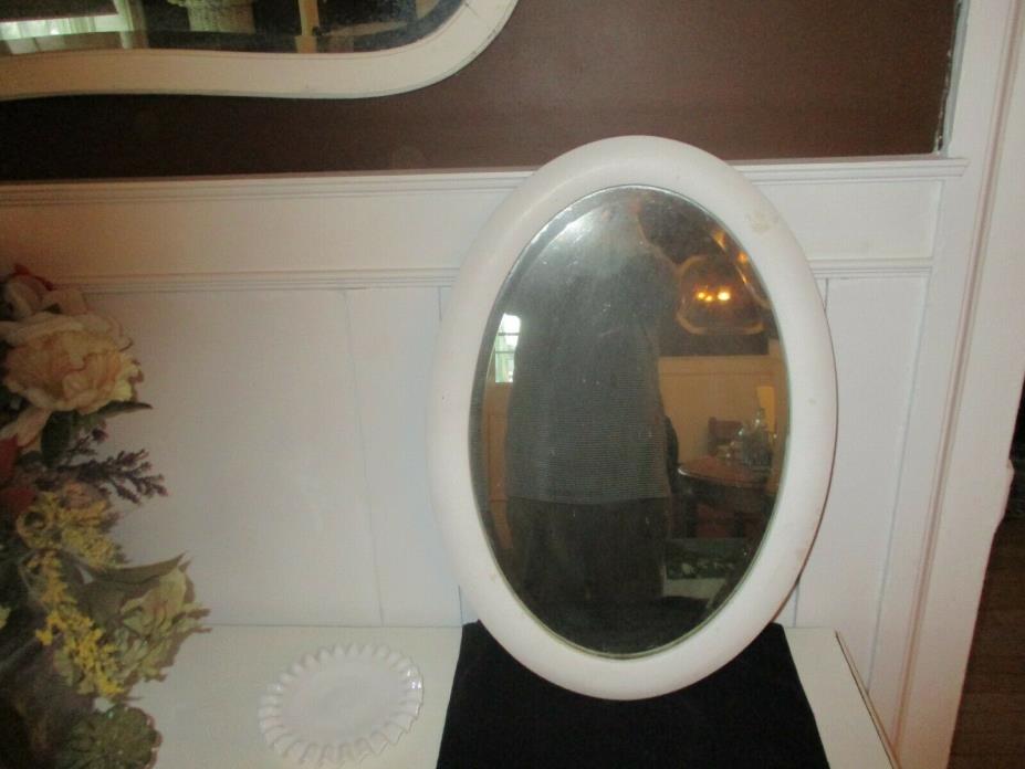 Antique beveled oval mirror. Creamy white.