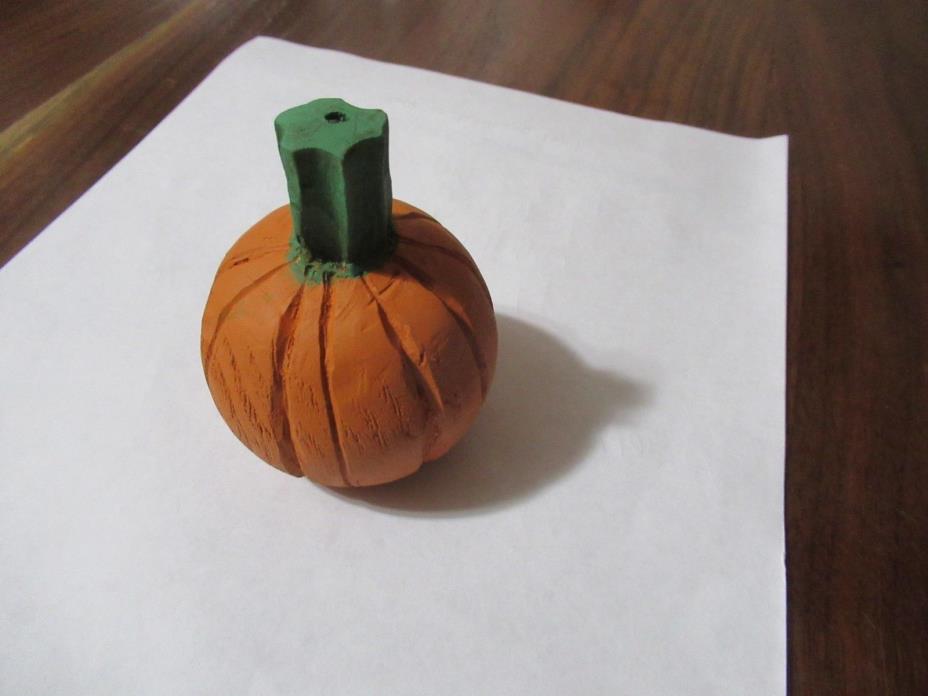 Hand carved wood pumpkin. Carved from basswood and is painted. About 2 inches