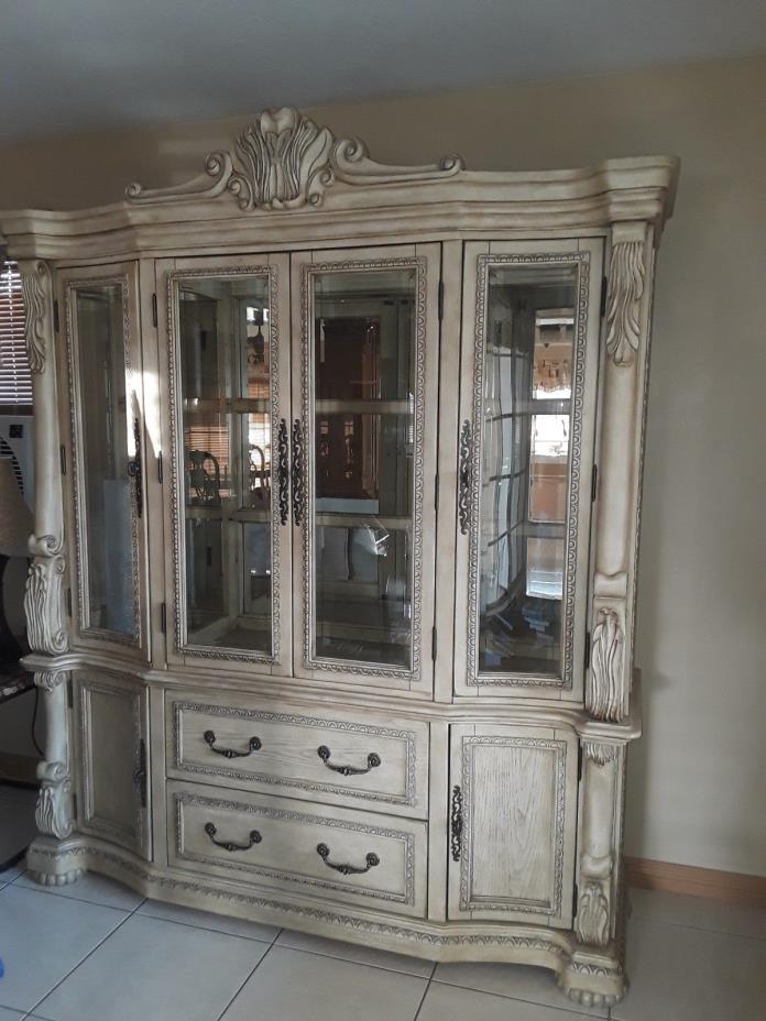 Large antique white china hutch. Four glass doors, two drawers, two cabinets.