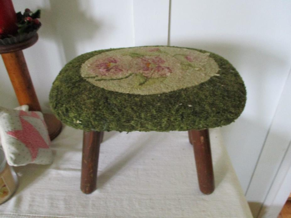 Vintage footstool with hooked flowers top cover.