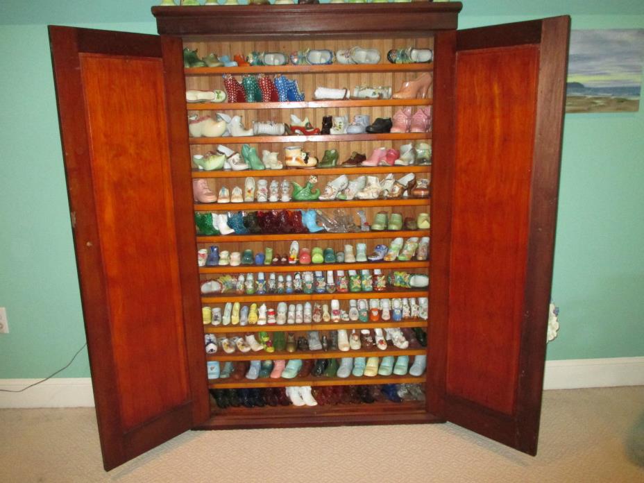 COLLECTION OF 178 GLASS AND CERAMIC SHOES PLUS ANTIQUE CABINET