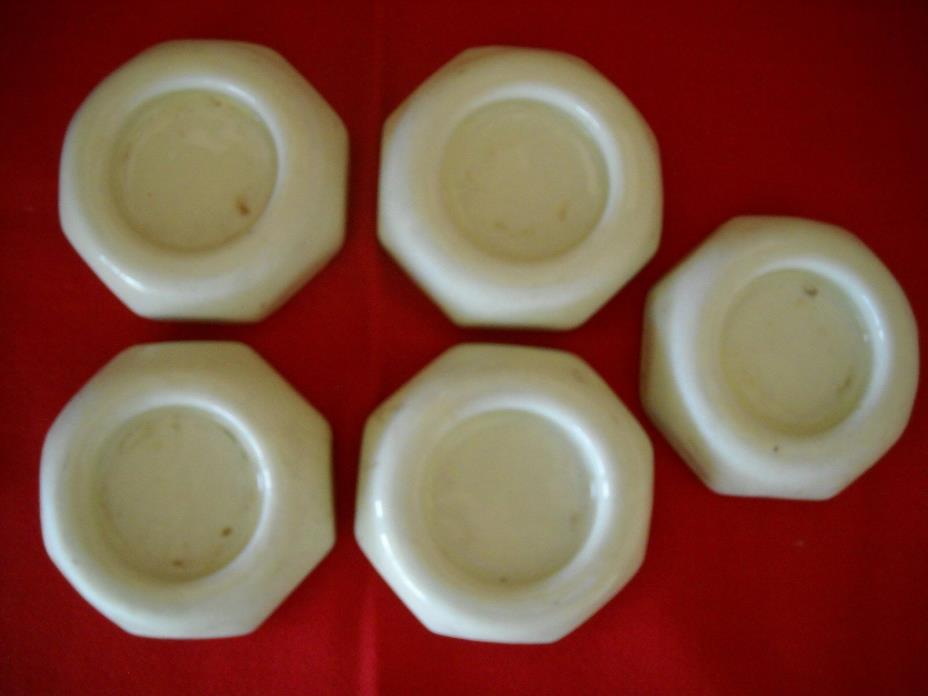 Antique set of 5 creme ceramic furniture casters.