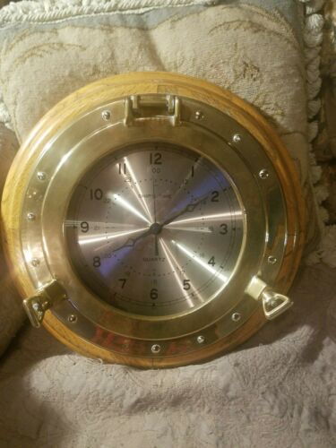 A vintage ship time brass and wood clock