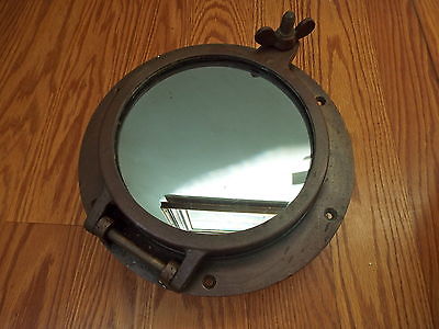 VINTAGE HEAVY BRASS PORTHOLE WITH MIRRORED ONE WAY GLASS AND BRASS SCREEN