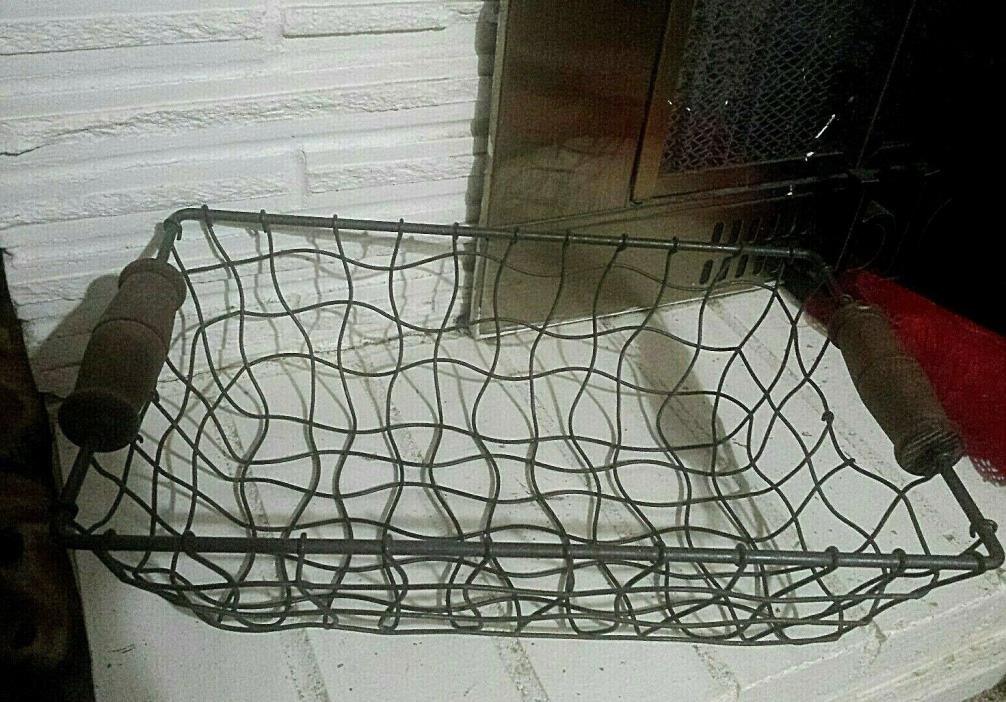 OLD FACTORY? METAL STURDY BASKET, WITH WOOD HANDLE.  VERY UNIQUE WIRE CURVES..