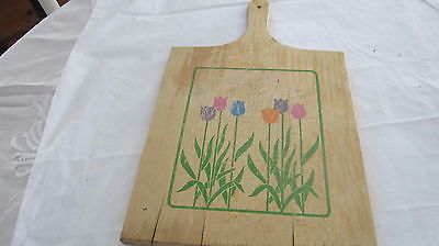 Vintage cutting board with tulip flowers. Has a handle.