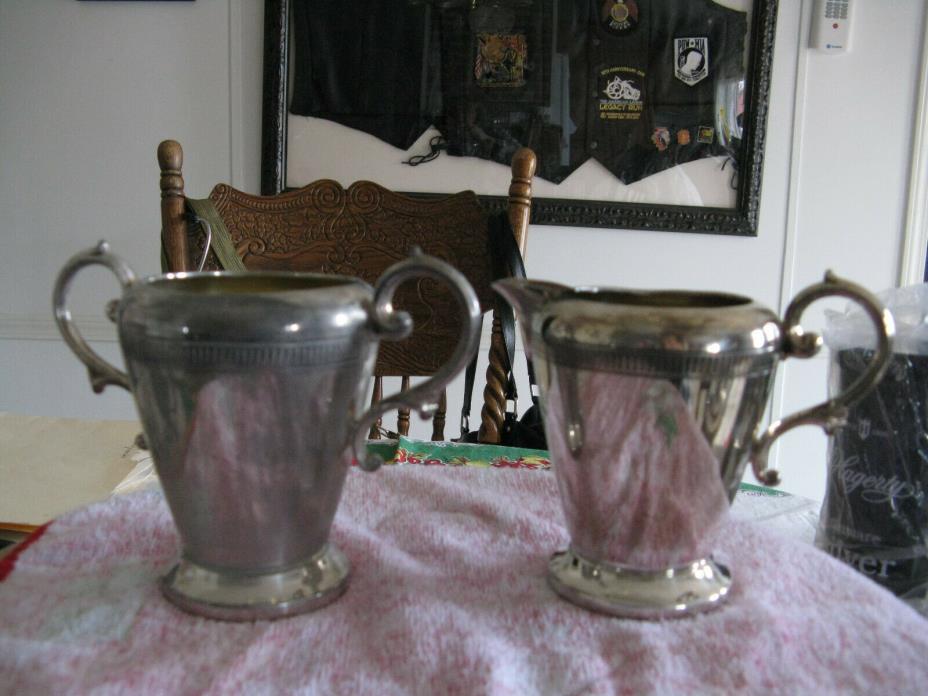 tall silver plated sugar and creamer4 1/5 in Canisil LTD imprinted on sugar bowl