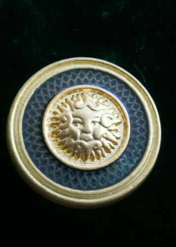 Pre owned metal mythology face gold tone with enamel clothes button.
