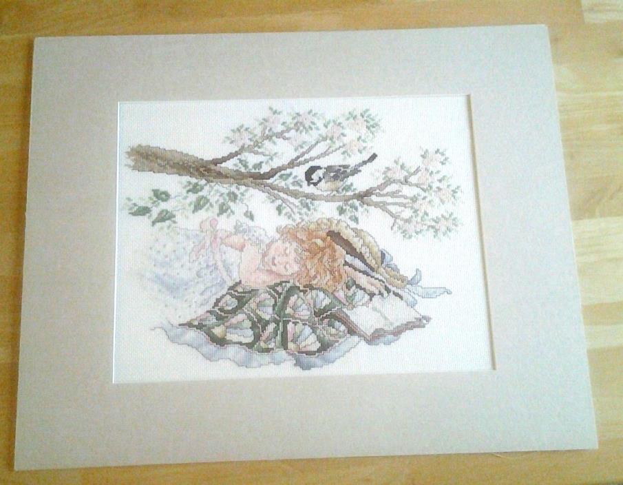 Finished Cross Stitch of Girl Sleeping with open book under tree  with bird