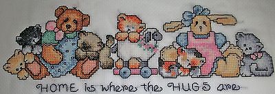 Finished cross stitch piece- Toys/Home is where the hugs are