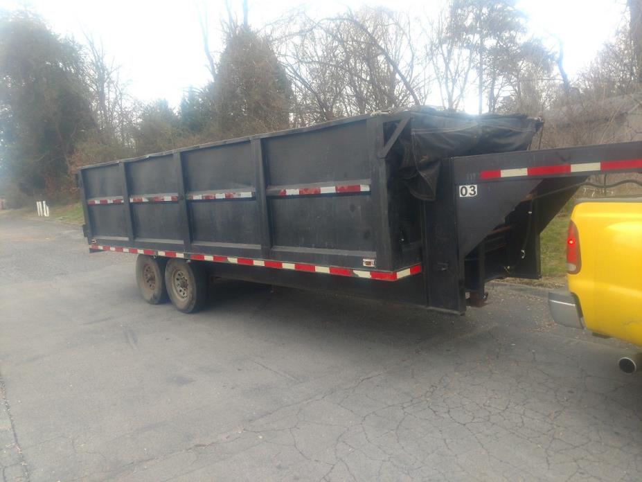 slightly used black metal gooseneck dump trailer