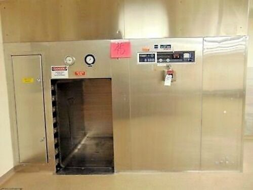 Getinge 6910 Autoclave with Pass Through Doors and 2 Stainless Steel Carts