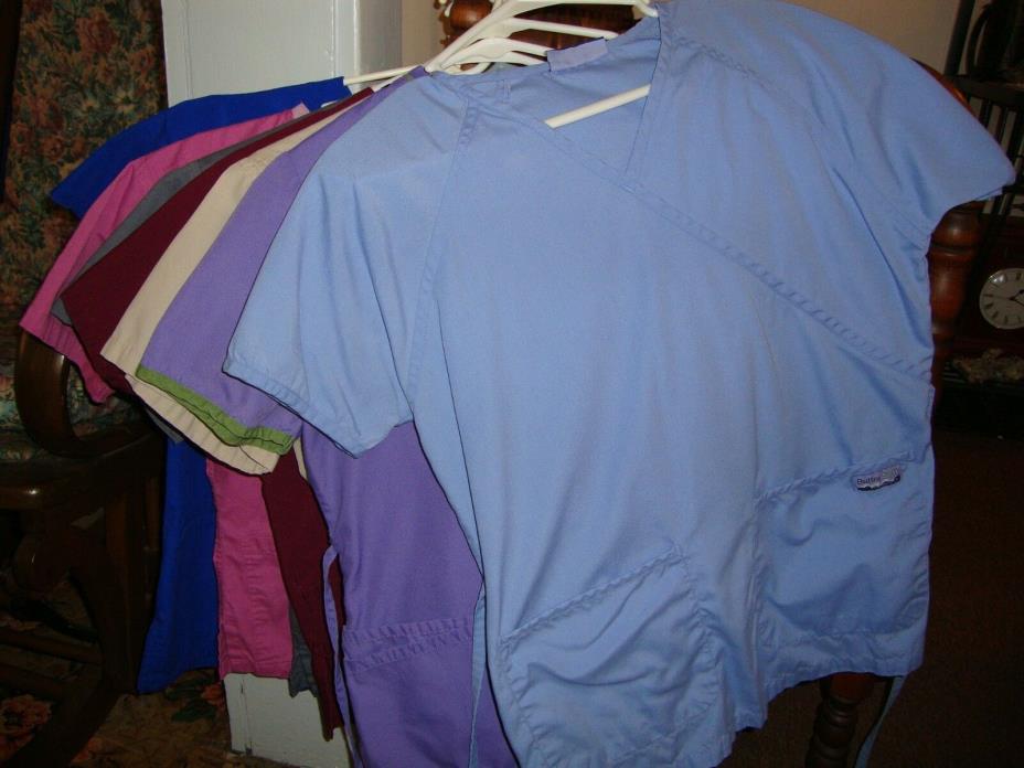 23 women's scrubs tops.  Mostly medium, some small, gently used.