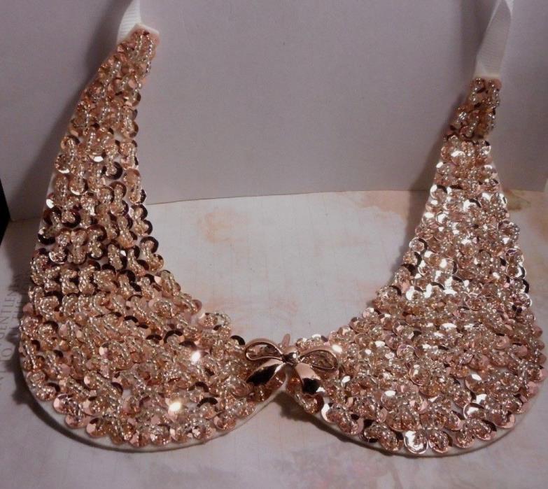 Gold colored collar with beads and glitter ties to your blouse or sweater collar