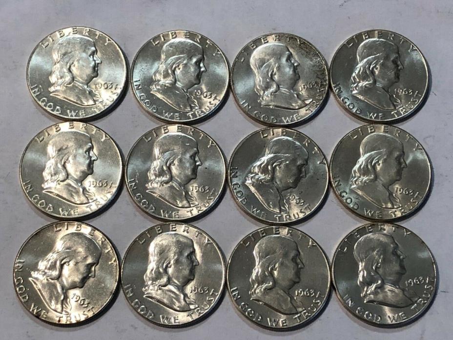 TWELVE BU 1963 Franklin silver half dollars.