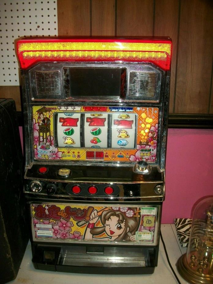 JAPANESE GAME MACHINE TOKENS ONLY IT LIGHTS UP STILL SELL AS IS I DONT HAVE TOKE