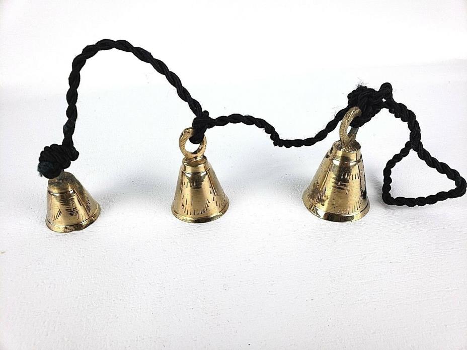 3 Brassy Bells Strung on a Black Rope India Same Shape Different Sizes