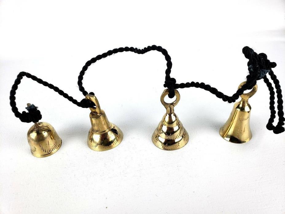 4 Brassy Bells Strung on a Black Rope India Different Shapes Different Sizes