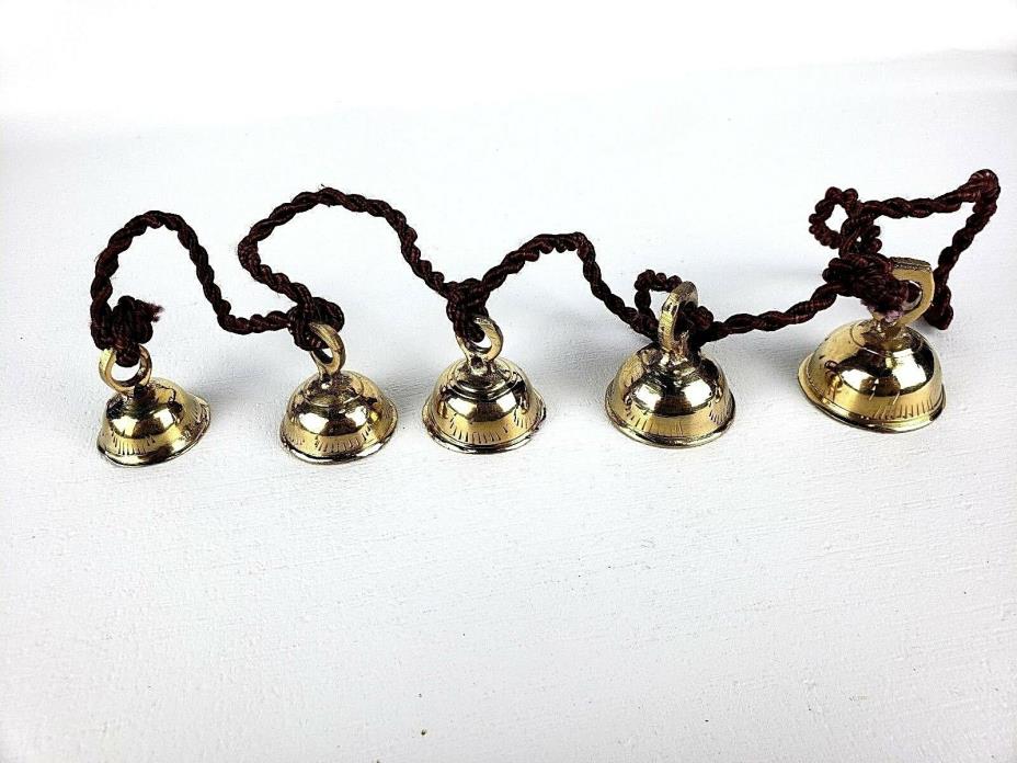 5 Brass Bells Strung on a Brown Rope India Same Shape Different Sizes