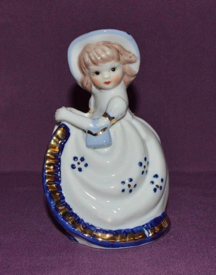 PORCELAIN (BELL) FIG. OF BEAUTIFUL YOUNG GIRL DRESSED IN WHITE W/BLUE/GOLD TRIM
