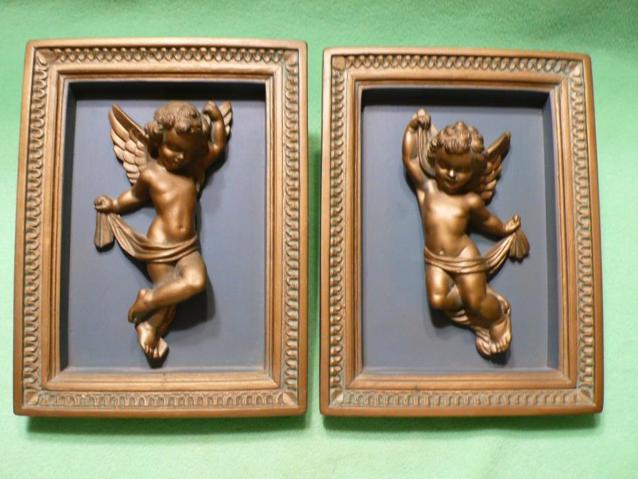 Set of two vintage CHALKWARE Cherub sculptures framed in chalkware wall plaques.