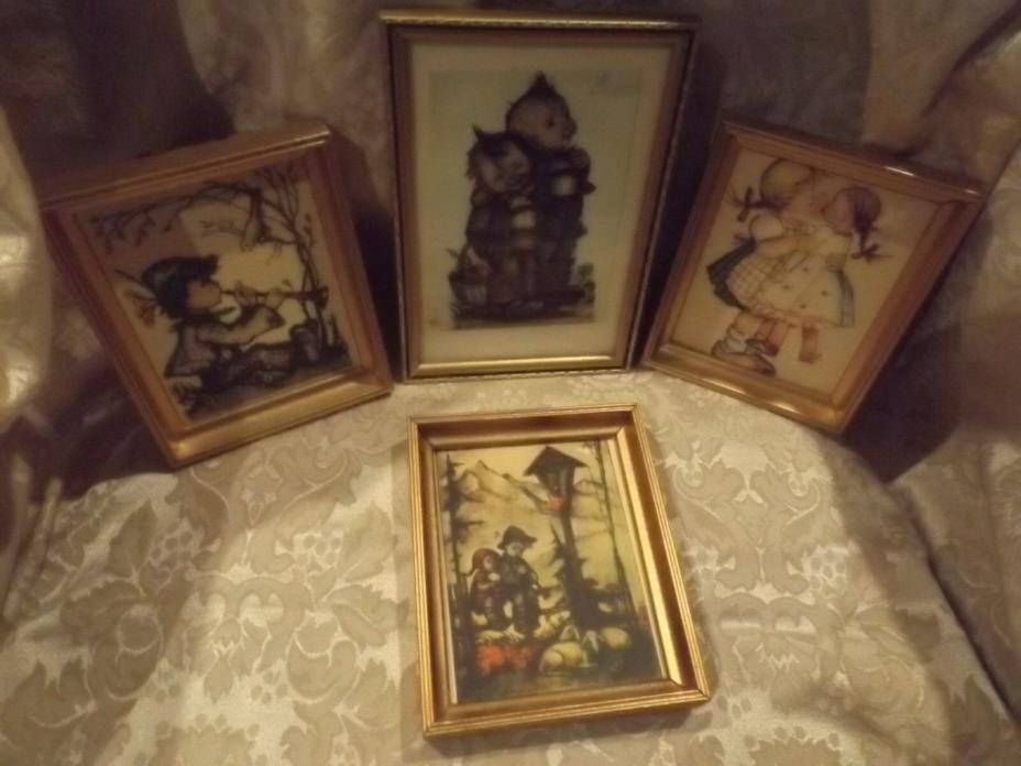 4 gold framed vintage Hummel prints.