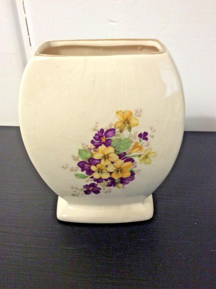 Small vintage cream colored vase with yellow and purple pansies