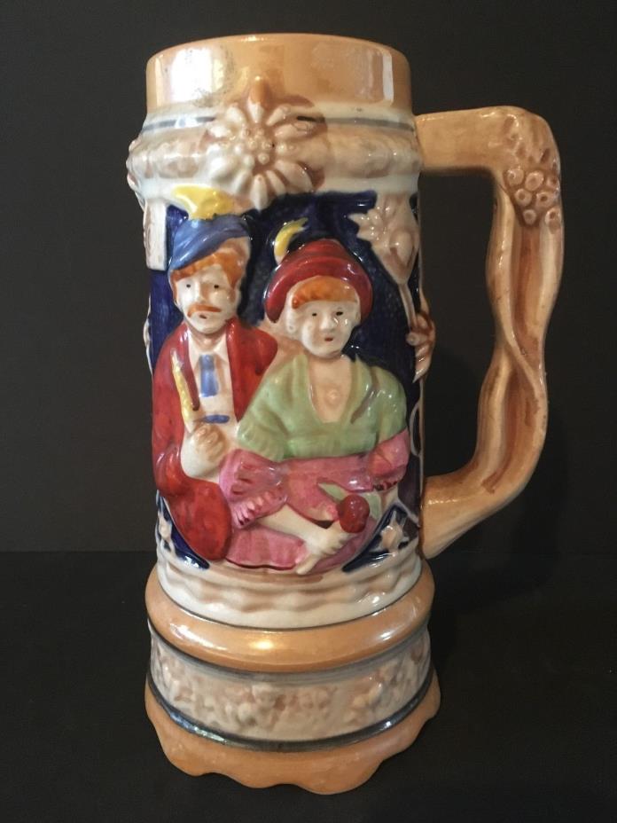 vintage stein hand painted rised man and lady on base