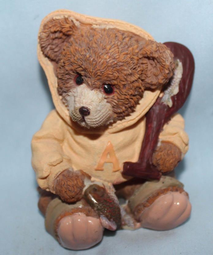 Bear figurine with fish and paddle. Hoodie w/ letter A