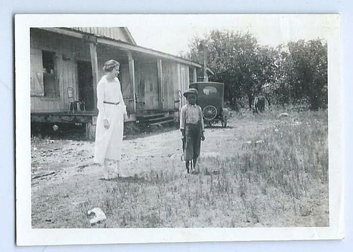 Pair of 1910's snapshot photographs of a white woman & African American boy