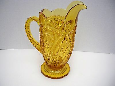 AMBER PRESSED GLASS PITCHER WITH ORNATE DESIGN
