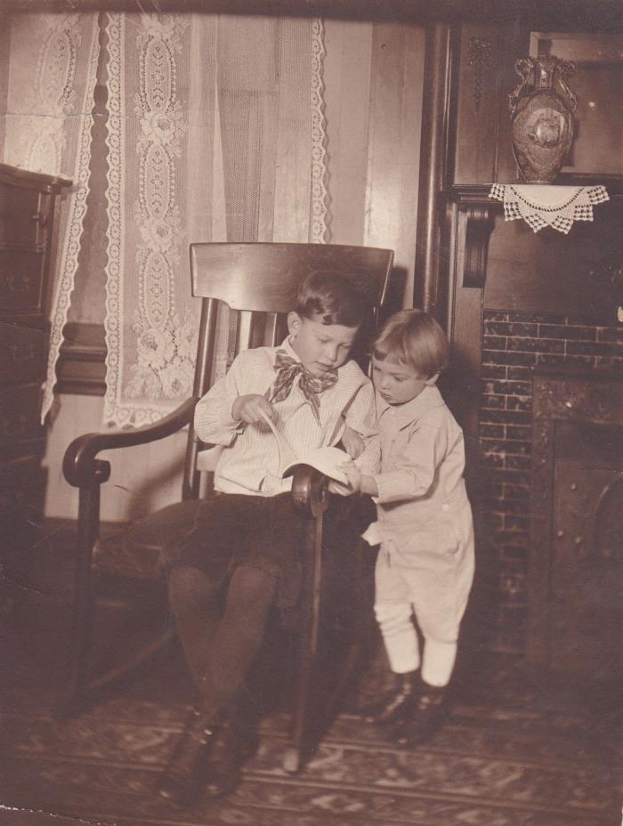 TWO BROTHERS - CHUCK AND KENNY - READING A BOOK  BY FIREPLACE - VINTAGE PHOTO