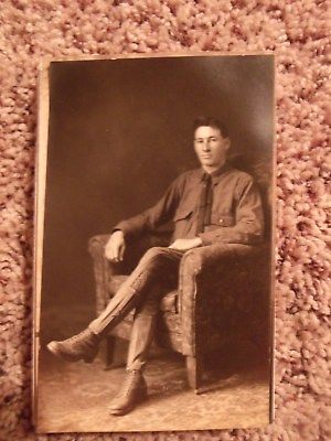 VINTAGE RRPC POSTCARD YOUNG MAN SITTING MILITARY UNIFORM CROSSED LEGS, NO HAT