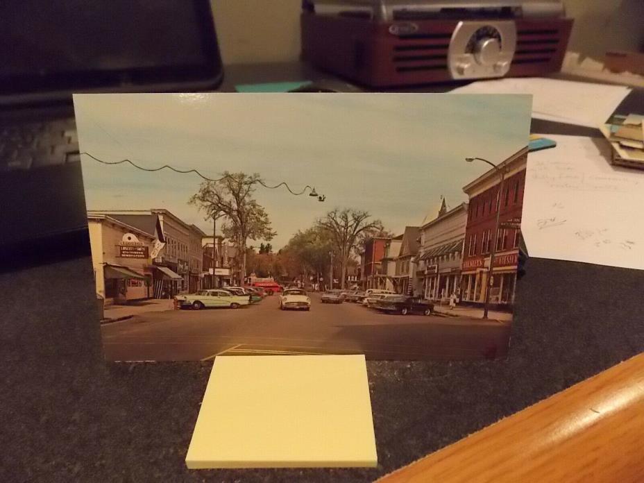 STREET SCENE LANCASTER, N.H. PLASTICHROME POSTCARD- STORE FRONTS-VINTAGE CARS