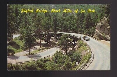 Pigtail Bridge in the Black Hills of South Dakota shows older station wagon car