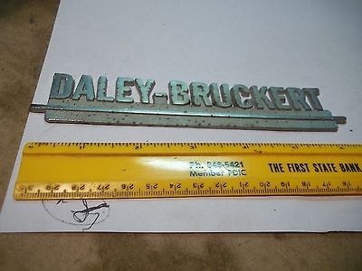 Old Metal Car Dealer Emblem Daley Bruckert