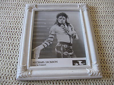 WHITE FRAMED PRESS PHOTO OF MICHAEL JACKSON ON STAGE 