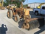 Case IH 380 tractor with broom