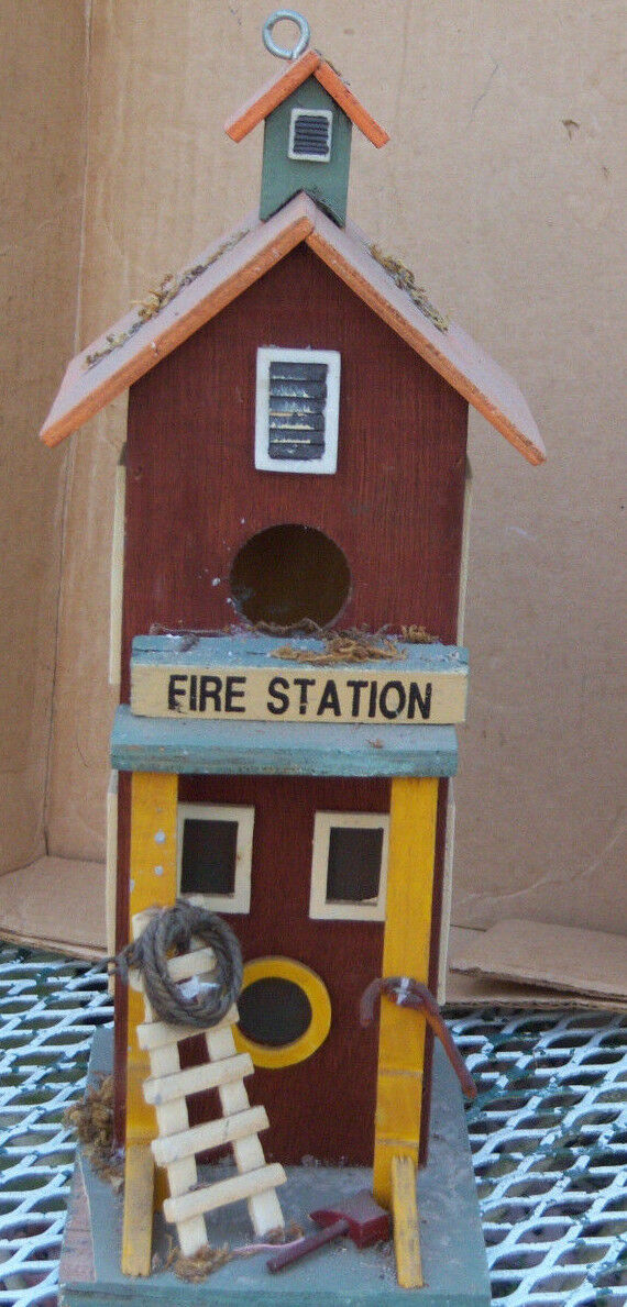 Wooden fire station birdhouse with fire equipment decorations