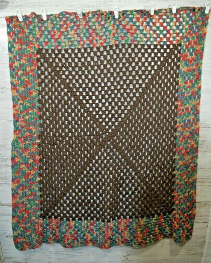 Brown, pink, green, blue and yellow crocheted blanket afghan