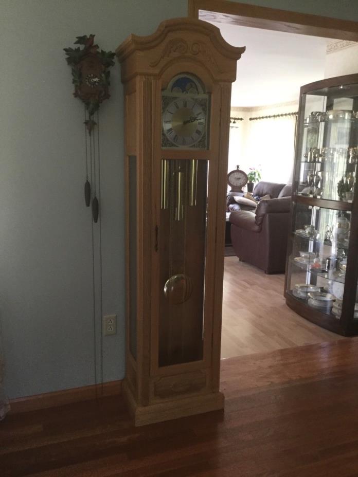 Grandfather  clock. Howard Miller. Light oak.