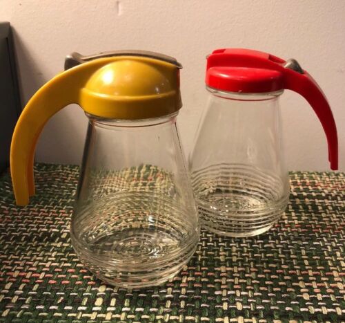 Two Vintage Ribbed Glass Syrup Pitcher Yellow And Red Hard Plastic Lids
