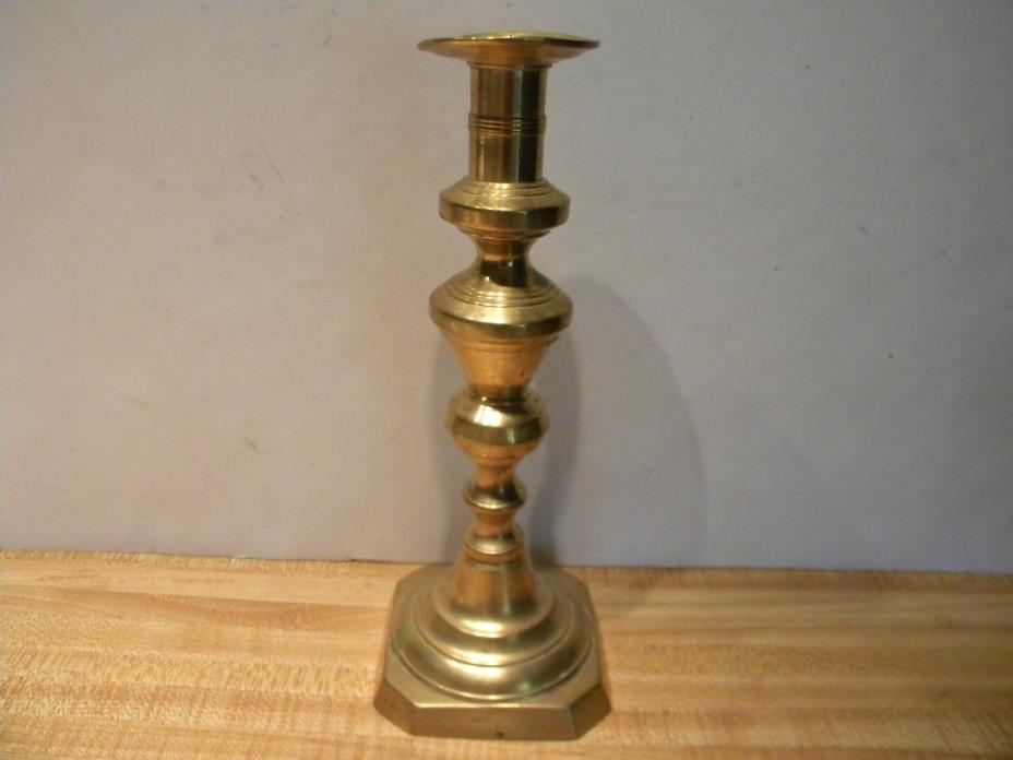 A Tall Antique Brass Push-Up Candlestick