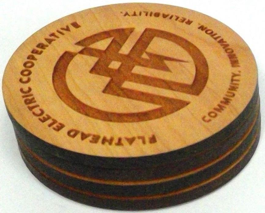 set 4 oak coasters Flathead Electric Coop logo 'Communication/Innovation...'