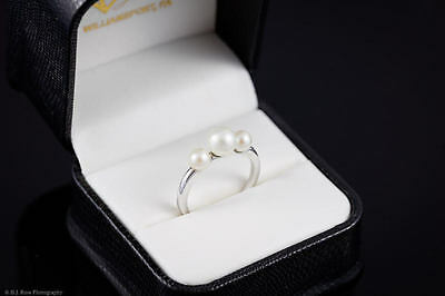 White pearl ring with 3 pearls and a 14 karat white gold band- size 8