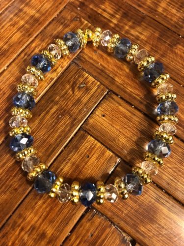 Pretty 6x8mm Blue Glass Crystals, Clear Crystals and Bali Gold. Stretch Bracelet