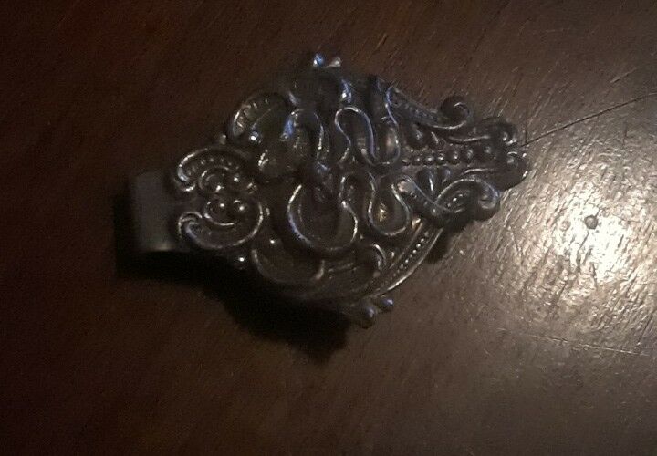 Vintage money clip with beautiful designs unknown if sterling? see pics