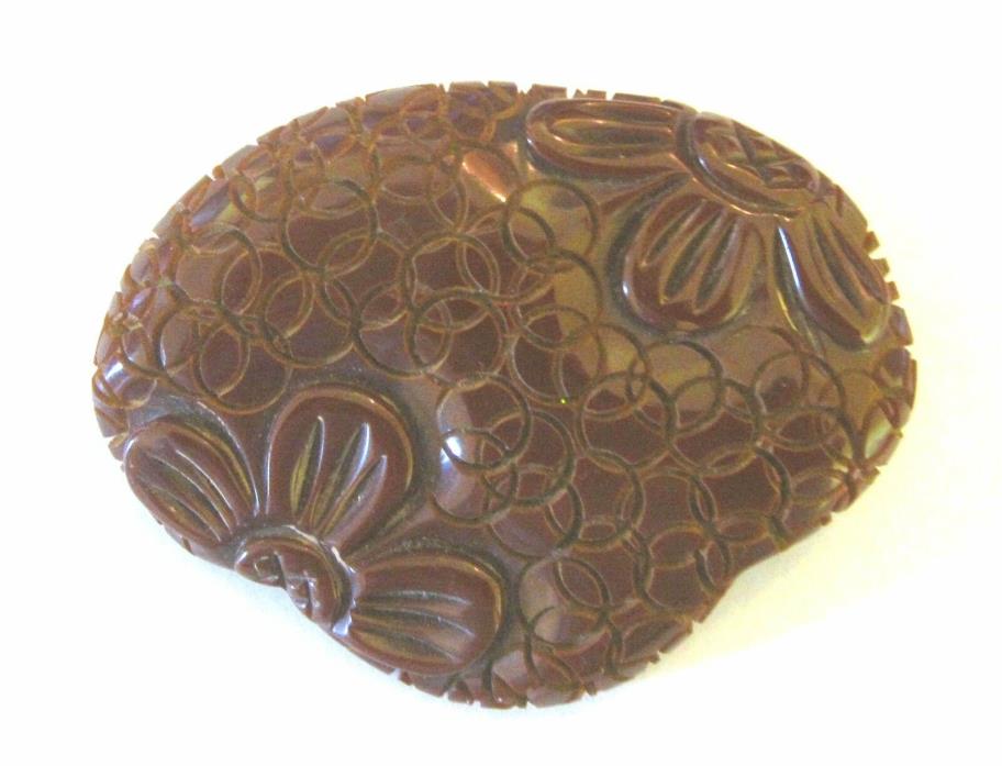 Carved brown Bakelite brooch. Flower design.