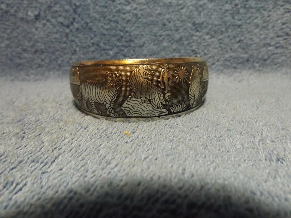 Vintage Silver Tone Bangle Bracelet with Tigers, Floria & Mountains on side.